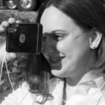 Karla Houdek, that cheerful voice on the phone when you call Good Old Boat, tries out the floating signal mirror the editors bought for their boat.