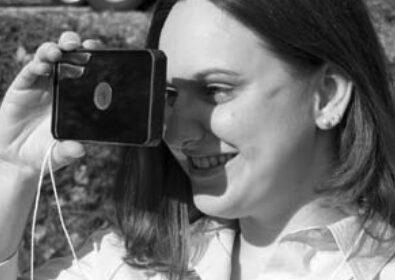 Karla Houdek, that cheerful voice on the phone when you call Good Old Boat, tries out the floating signal mirror the editors bought for their boat.