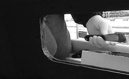 Mark Petrush fills the liner-cabin trunk gap. His gap was relatively wide. Once the first layer of filler sets up, the clamps can be removed.
