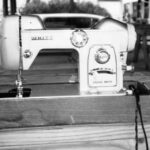 Home sewing machine doing duty outdoors.
