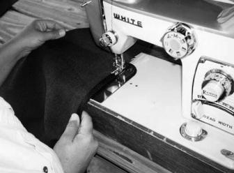 Sewing binding tape onto acrylic outdoor fabric.