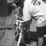 The operator connects his hoses to the soda-blasting equipment.