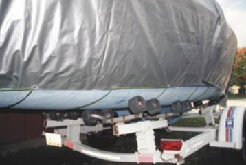 Starting under the bow of the boat and working toward the stern, a line is woven back and forth through the tarp’s grommets, securing the tarp to the boat.