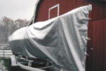 The tarp has been sized not only to cover the boat from stem to stern, but also from waterline to waterline, leaving only last season’s bottom paint exposed to the elements.