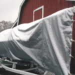 The tarp has been sized not only to cover the boat from stem to stern, but also from waterline to waterline, leaving only last season’s bottom paint exposed to the elements.