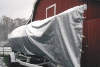 The tarp has been sized not only to cover the boat from stem to stern, but also from waterline to waterline, leaving only last season’s bottom paint exposed to the elements.