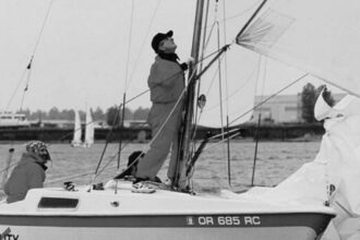 Steve Rander’s Cal 20, Reality Check, started the Portland Cal 20 fleet. Steve bought the boat when it was to be scrapped by a fellow who wanted just the mast. Steve gave him another mast in exchange and went on to start something big in Portland. In the photo at left, Steve’s at the helm, Lynne Hemmert is adjusting the spinnaker, and Todd Johnson is hidden from view.