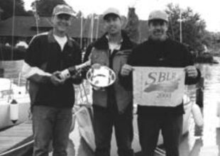 Doug Axtell is holding the silver, center, with friends Don Boesel, at left, and Kermit Sleggs, right.