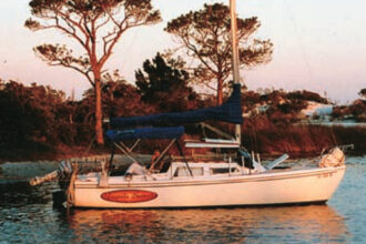 Tequila Sunset, anchored in an island cove on Choctawhatchee Bay, in Florida Panhandle waters. As here, they often set an anchor off the bow and tie the stern to a tree ashore.
