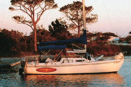 Tequila Sunset, anchored in an island cove on Choctawhatchee Bay, in Florida Panhandle waters. As here, they often set an anchor off the bow and tie the stern to a tree ashore.