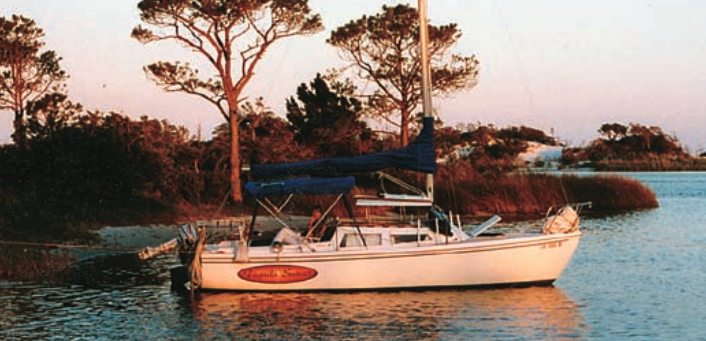 Tequila Sunset, anchored in an island cove on Choctawhatchee Bay, in Florida Panhandle waters. As here, they often set an anchor off the bow and tie the stern to a tree ashore.