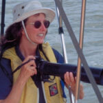 Picture of a woman with a camera on a boat