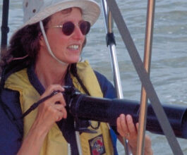 Picture of a woman with a camera on a boat