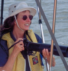 Picture of a woman with a camera on a boat