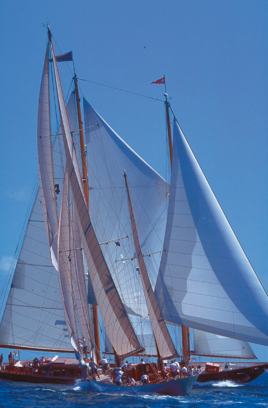 Belle Aventure, in foreground, is a 94-foot cutter-rigged steel ketch, designed by William Fife and built in 1929 by Fife’s, in Clyde, Scotland. Behind her looms Aschanti IV, a 103-foot Bermudan schooner designed and bult by Burmeister Shipyard in Bremen, Germany, in 1954.