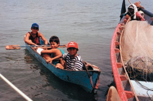 Young El Salvadorans in a dugout canoe visit Kestrel and crew off the town of La Union in the Bay of Fonseca.