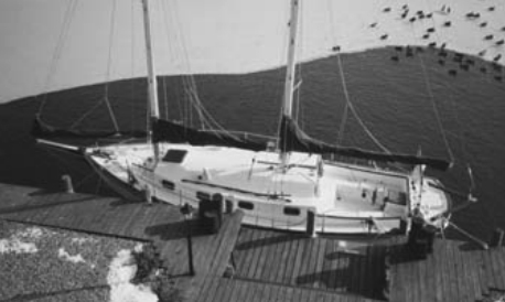 Mid-winter photo of the author’s schooner, Delphinus, at the dock next to his home in New Jersey. His boat is protected from ice around the hull by a water-agitation motor.