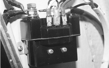 The reversing relay is mounted high and dry in a locker near the companionway.