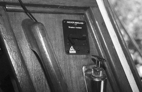 For easy access from the cockpit, the 50-amp circuit breaker and up/down toggle switch is mounted inside the companionway, adjacent to the controls for starting and stopping the engine.