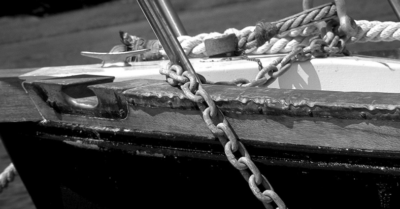 Copper flashing from the local hardware store or roofing supply company can be used to protect toerails from anchor chains.