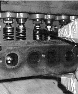 Adjust the jaws open just wide enough to fit over the valve spring and at a slight angle so that when the spring is compressed, they will be parallel.