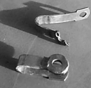 These stainless steel rigging fittings incorporate washers welded to the tang in an effort to increase the bearing surface. The result was weld decay; the fitting that broke was on the headstay. It let go during a rough offshore passage to windward. If not for an inner forestay, Mark would have lost the rig.