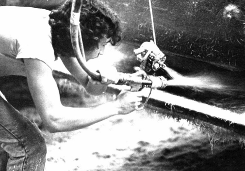 Chopper gun in use. At the very least, this worker should be wearing goggles and a respirator. Skin protection is also important. (Photo courtesy of Owens-Corning Fiberglass Corp.)
