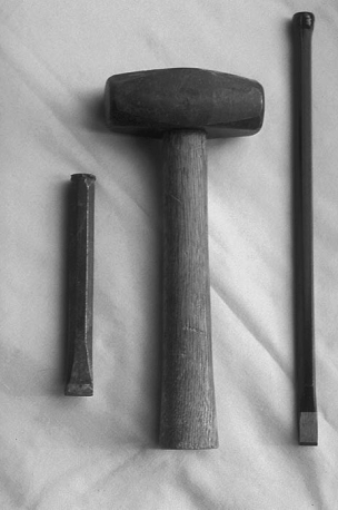 Cold chisels and a two-pound hammer are used to break the fault line once a stubborn nut has been weakened.