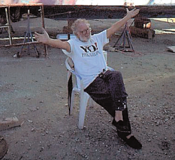 Picture of a man sitting in a boatyard